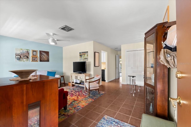 tiled living room with ceiling fan