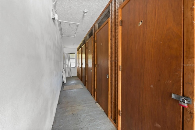 hallway with a textured ceiling