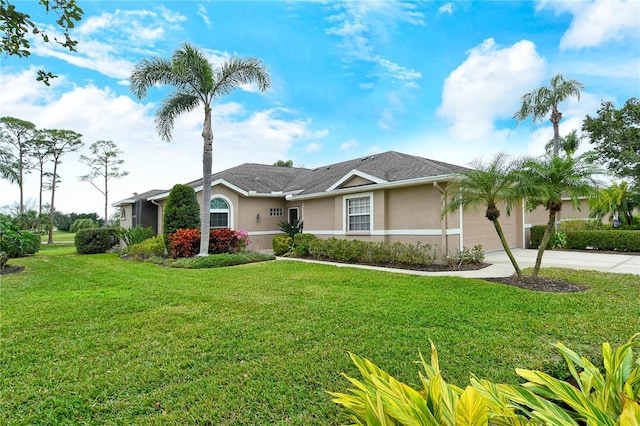 ranch-style home featuring a garage and a front lawn