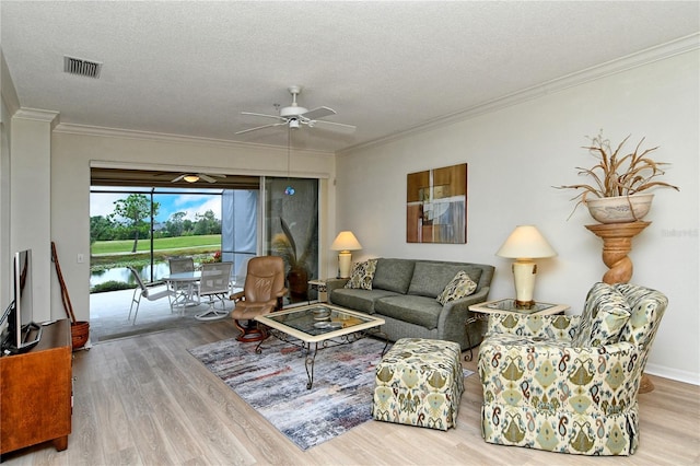 living room with ceiling fan, crown molding, hardwood / wood-style floors, and a textured ceiling