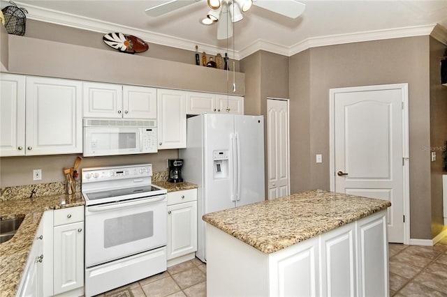 kitchen with a kitchen island, white cabinets, crown molding, light stone countertops, and white appliances