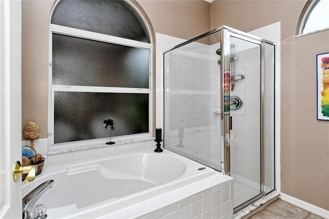 bathroom featuring tile patterned floors and independent shower and bath