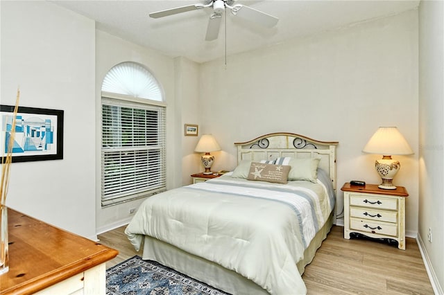 bedroom with light hardwood / wood-style floors and ceiling fan