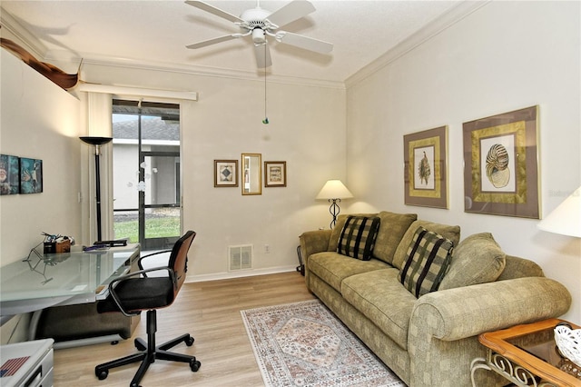 office space with ceiling fan, ornamental molding, and light hardwood / wood-style floors