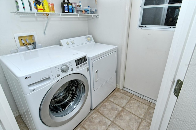 clothes washing area featuring separate washer and dryer