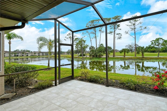 unfurnished sunroom featuring a water view