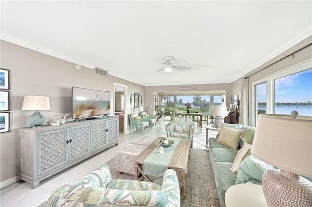 tiled living room featuring ceiling fan, a healthy amount of sunlight, and ornamental molding