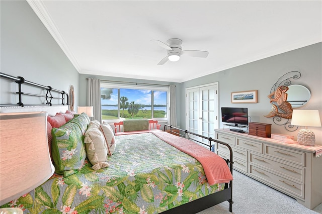 carpeted bedroom with crown molding, ceiling fan, a closet, and french doors