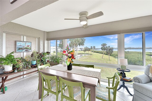 sunroom / solarium featuring ceiling fan