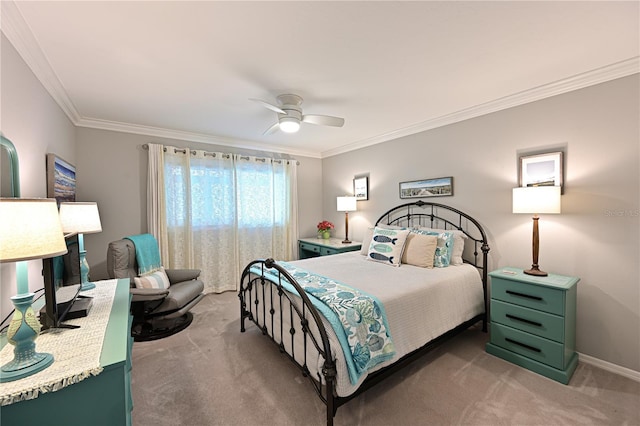 carpeted bedroom with baseboards, ornamental molding, and a ceiling fan