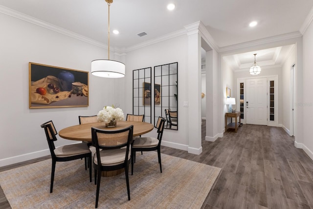 dining room featuring dark hardwood / wood-style flooring and ornamental molding