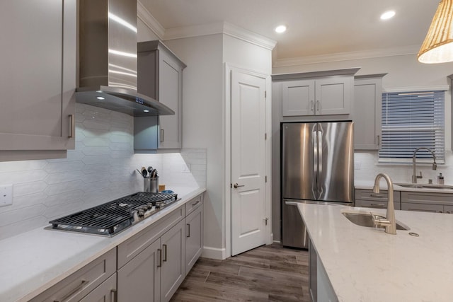 kitchen featuring gray cabinetry, stainless steel appliances, sink, and wall chimney range hood