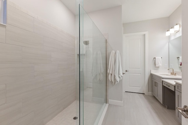 bathroom with vanity and a tile shower