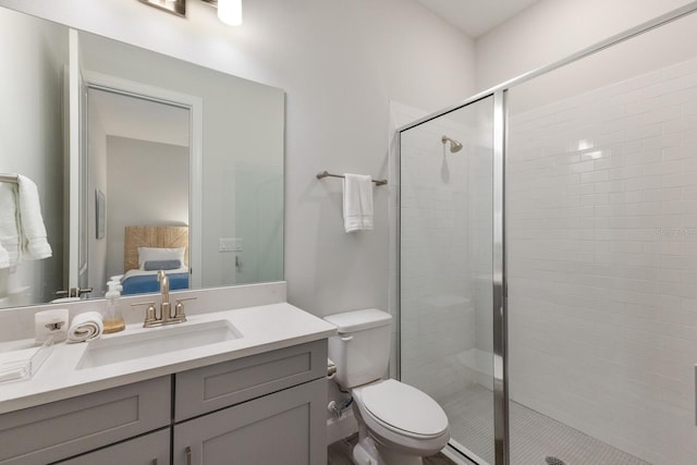 bathroom featuring vanity, toilet, and a shower with shower door