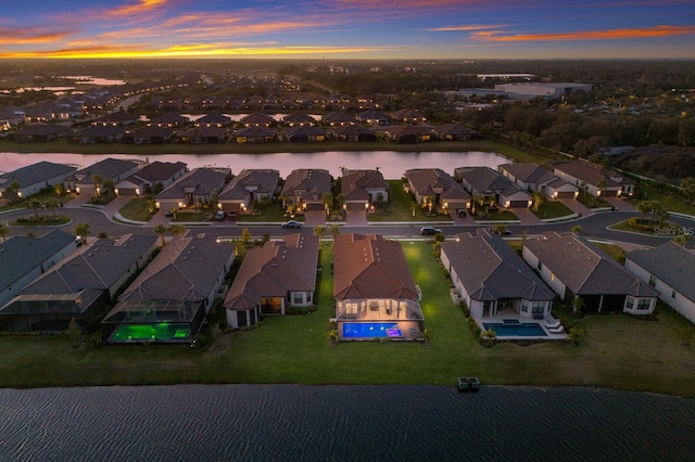 aerial view at dusk with a water view