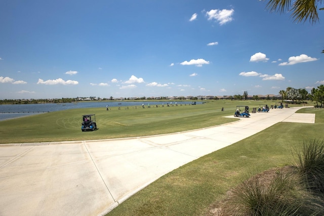 view of property's community featuring a water view and a yard