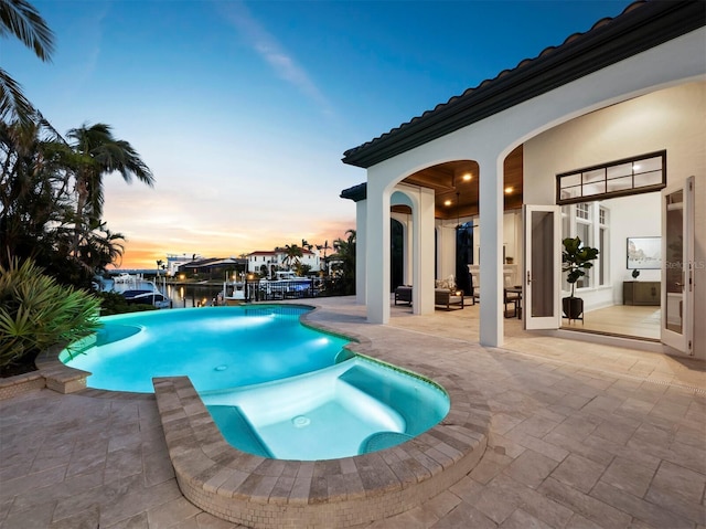 pool at dusk with a patio