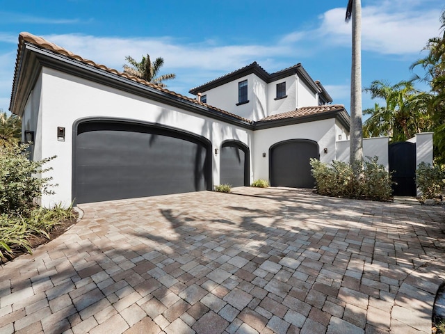 mediterranean / spanish-style house with a garage