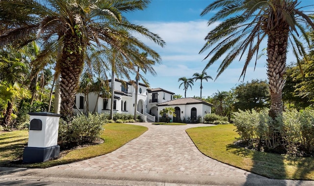 mediterranean / spanish-style house with a front yard