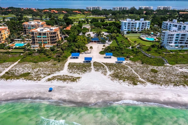 drone / aerial view featuring a water view and a beach view