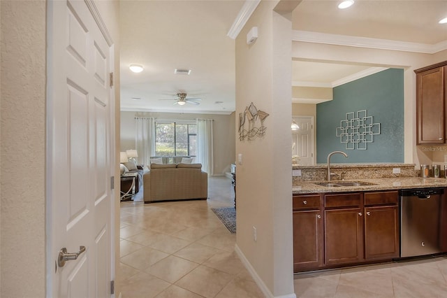 kitchen with sink, light tile patterned floors, ornamental molding, dishwasher, and light stone countertops