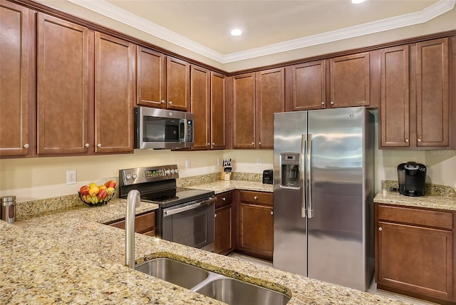 kitchen featuring light stone countertops, appliances with stainless steel finishes, sink, and crown molding