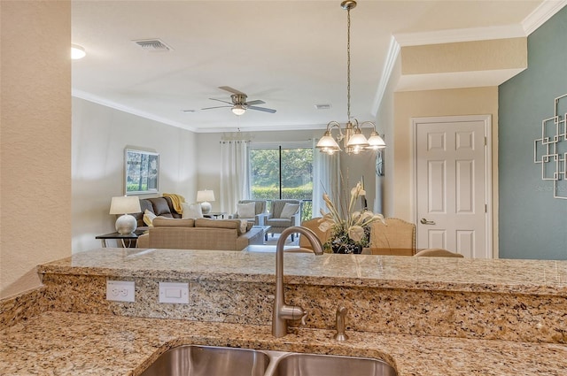 kitchen with crown molding, sink, and pendant lighting