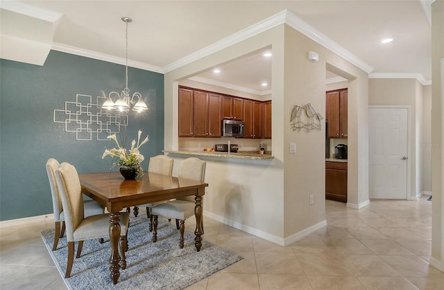 tiled dining room with an inviting chandelier and ornamental molding