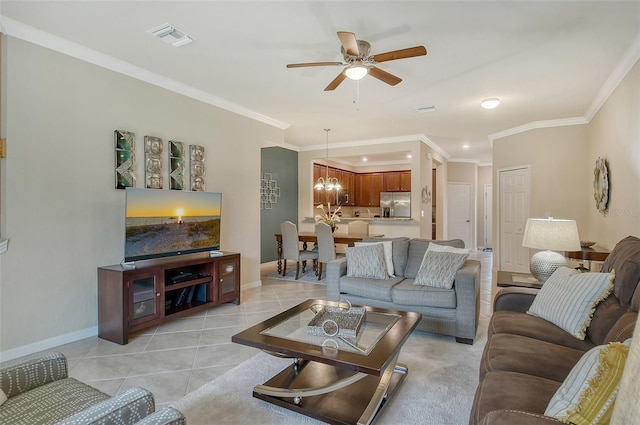 tiled living room featuring ceiling fan with notable chandelier and ornamental molding