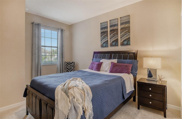 bedroom featuring light colored carpet