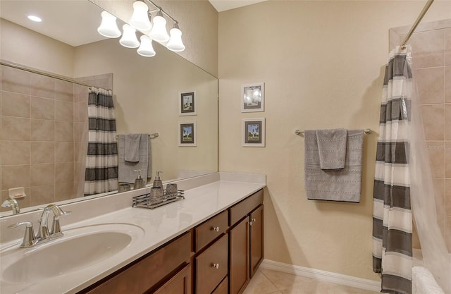 bathroom with an inviting chandelier, vanity, curtained shower, and tile patterned flooring