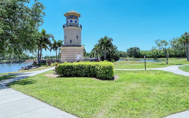 surrounding community featuring a yard and a water view