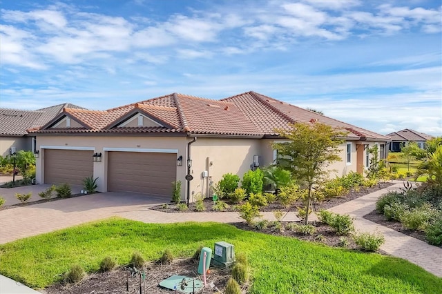 mediterranean / spanish-style home with a garage