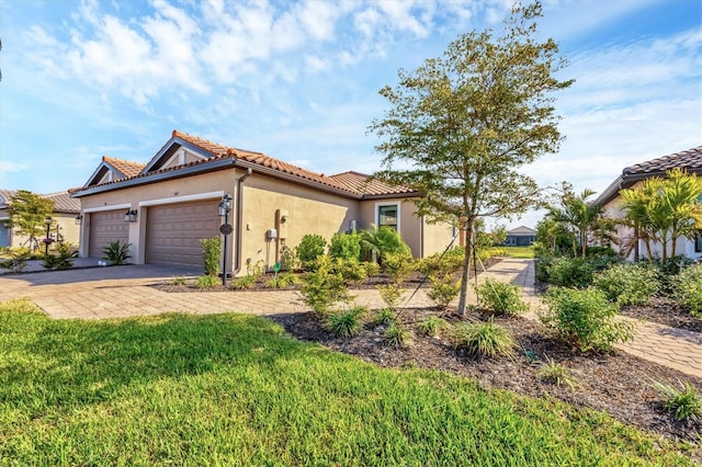 mediterranean / spanish-style home with a garage and a front yard