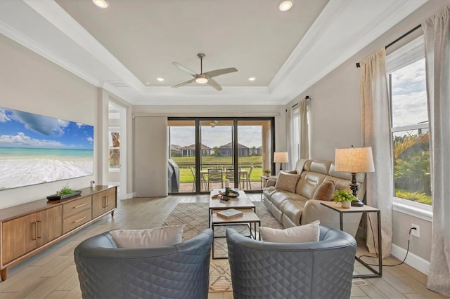 sunroom featuring ceiling fan and a tray ceiling