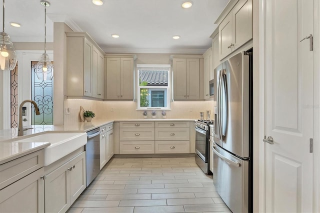 kitchen with stainless steel appliances, tasteful backsplash, sink, and decorative light fixtures