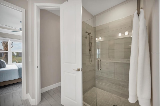 bathroom with ceiling fan and an enclosed shower