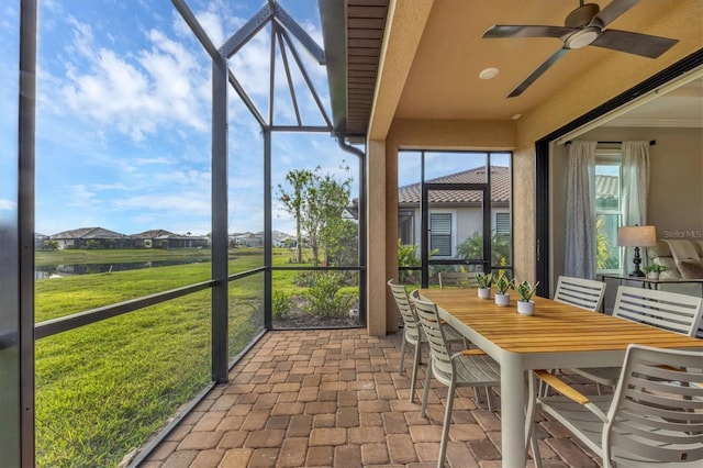 sunroom / solarium featuring ceiling fan