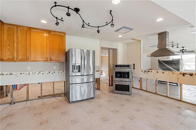 kitchen featuring stainless steel appliances and island exhaust hood