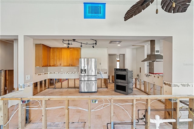 kitchen featuring appliances with stainless steel finishes and ventilation hood