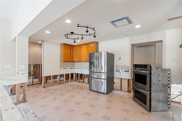 kitchen featuring stainless steel appliances and rail lighting