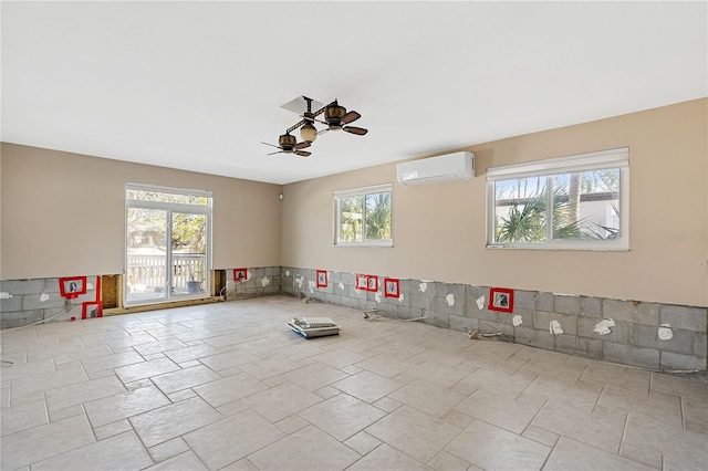 empty room with a wall unit AC and ceiling fan