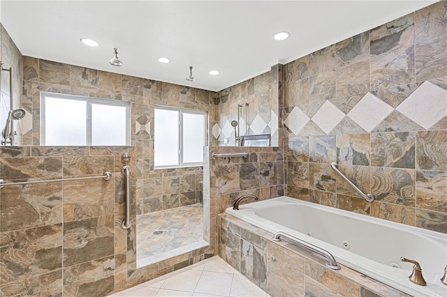 bathroom with tile walls, tile patterned floors, and separate shower and tub