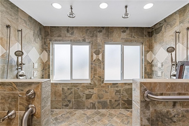 bathroom with a tile shower and ornamental molding