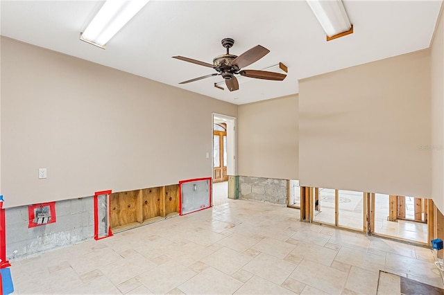 spare room with a wealth of natural light and ceiling fan