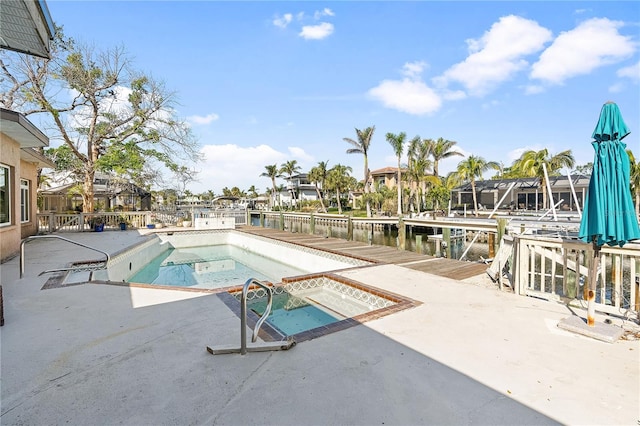 view of pool featuring a patio, a water view, and a jacuzzi