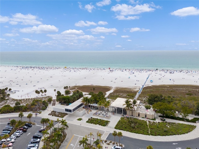 drone / aerial view with a beach view and a water view