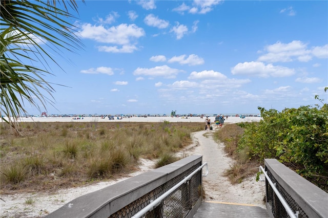 view of road featuring a water view and a view of the beach