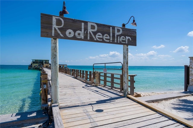 dock area with a water view and a view of the beach