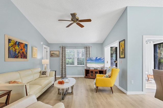 living room with lofted ceiling, light hardwood / wood-style floors, and ceiling fan